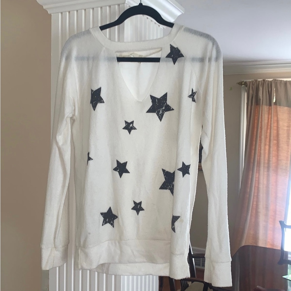 White sweater cut out in the front with black stars